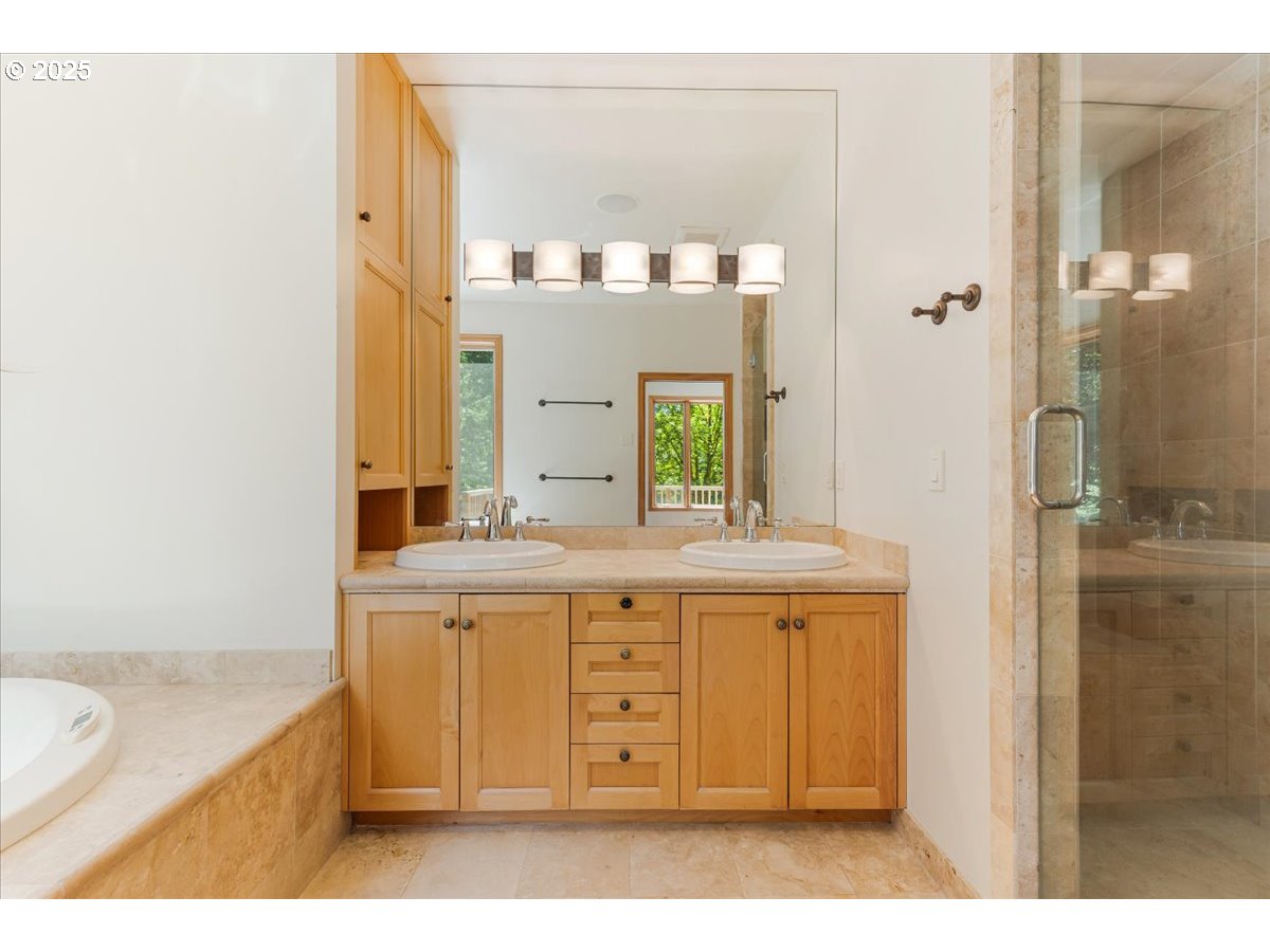 22500 Northwest Pihl Road Banks, OR 97106 - Photo 38 of 47 a bathroom with a granite countertop sink mirror and a bathtub
