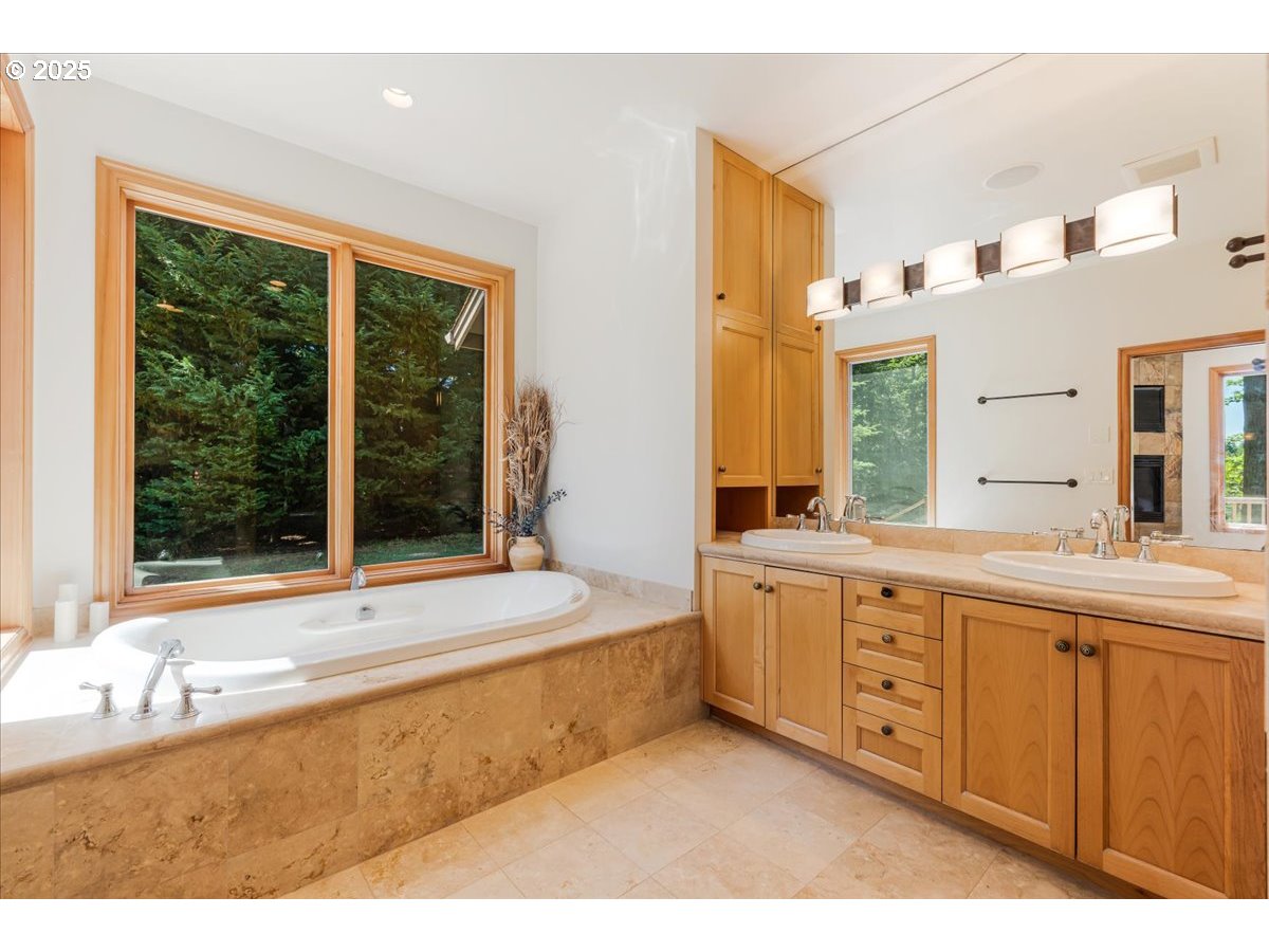 22500 Northwest Pihl Road Banks, OR 97106 - Photo 39 of 47 a bathroom with a tub a sink and a large mirror