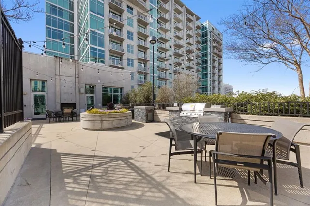 a view of a patio with couches table and chairs and potted plants