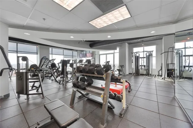 a living room with lots of furniture a chandelier and a rug