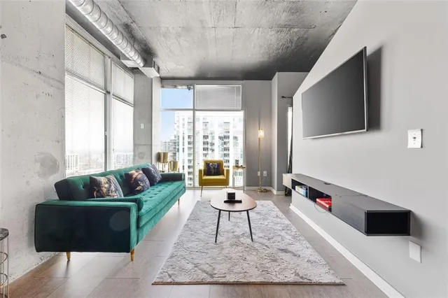 a living room with furniture and a flat screen tv