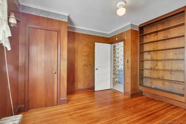a view of room with wooden floor and door