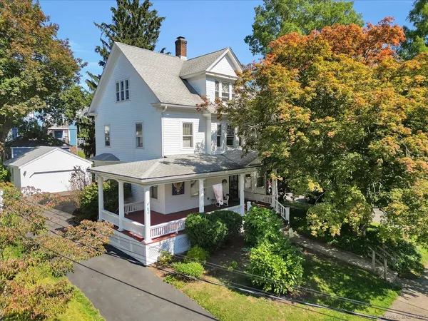 a aerial view of a house with a yard and potted plants
