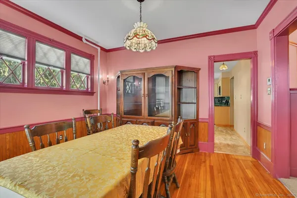 a view of a dining room with furniture and a chandelier