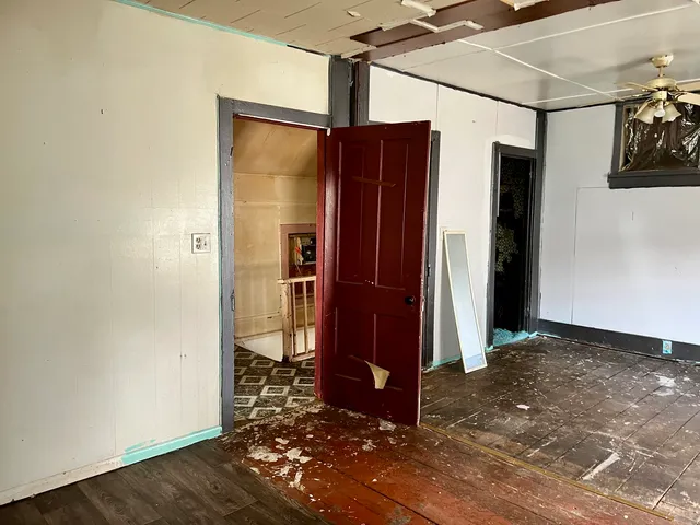 an empty room with wooden floor