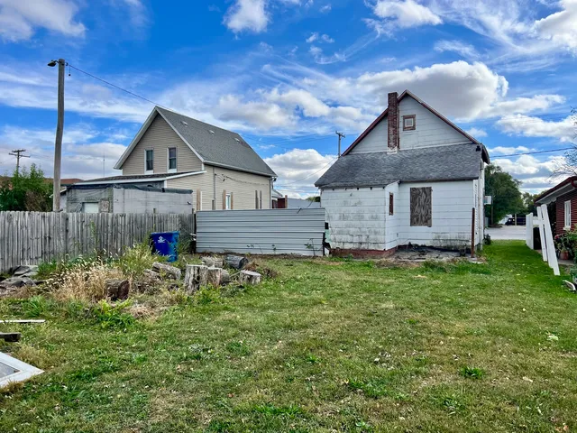 a front view of house with a garden