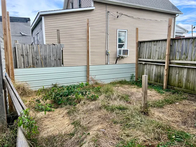 a view of a house with a yard and sitting area