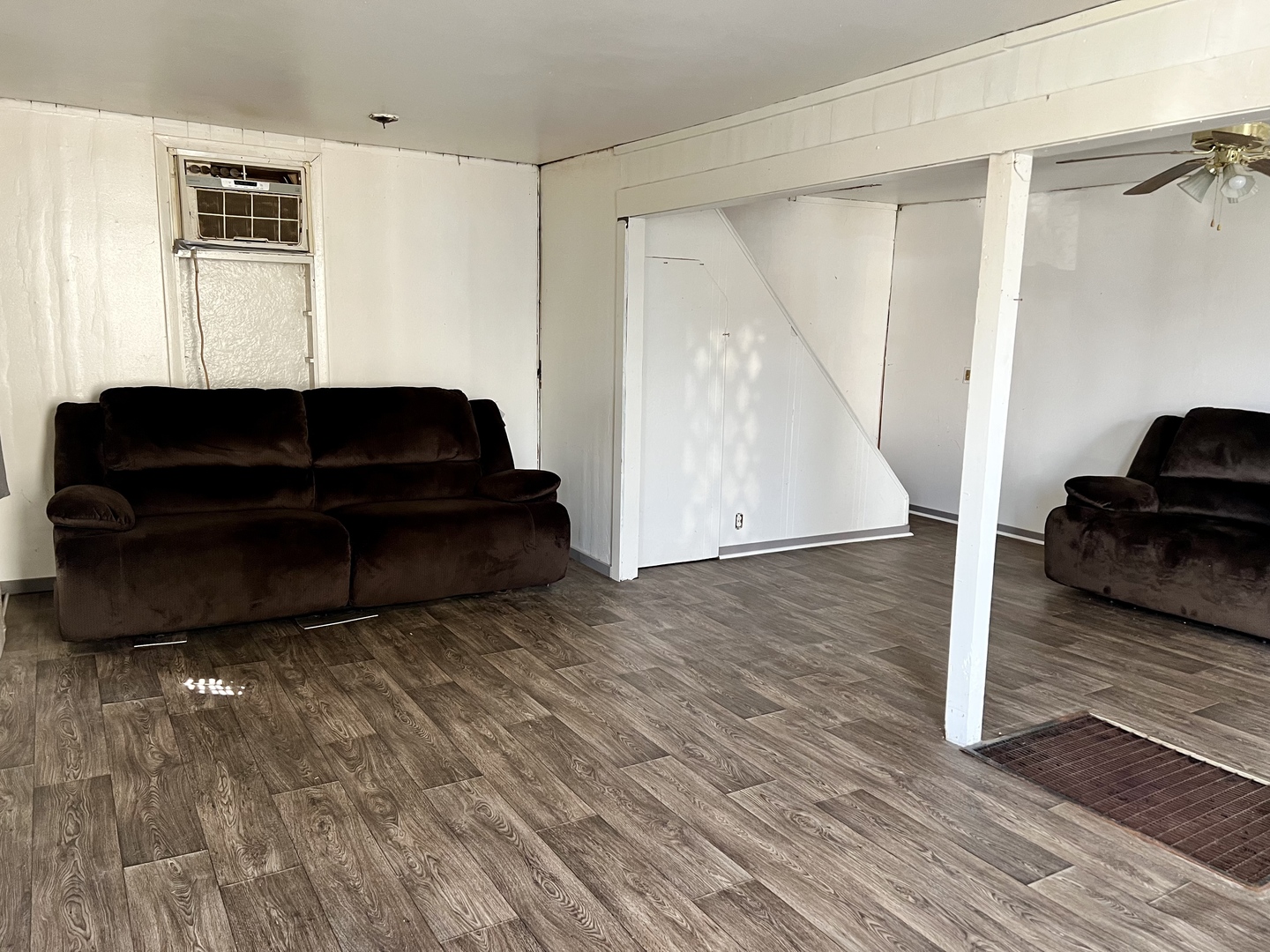710 West Main Street Hoopeston, IL 60942 - Photo 4 of 25 a living room with a couch and a potted plant on a wooden floor