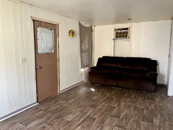 a living room with a bed furniture and a window