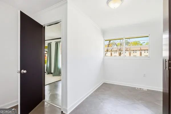 an empty room with windows and closet