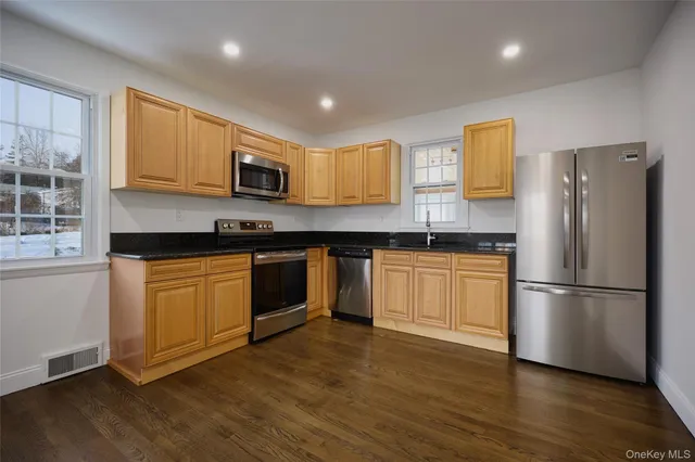 a kitchen with a refrigerator and a stove top oven
