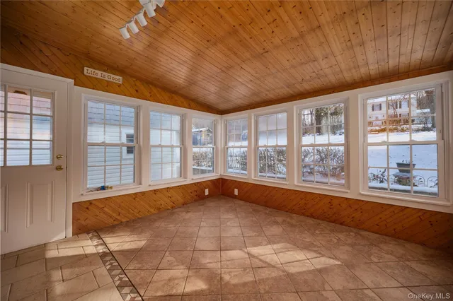 a spacious bedroom with a large bed and a large window