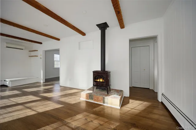 a living room with a fireplace furniture and a window