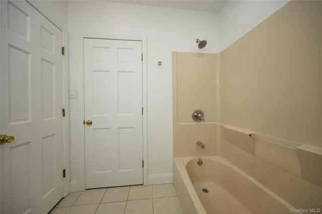 a bathroom with a bathtub shower and toilet