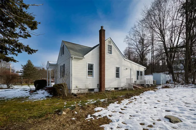 a view of a house with a yard covered in snow