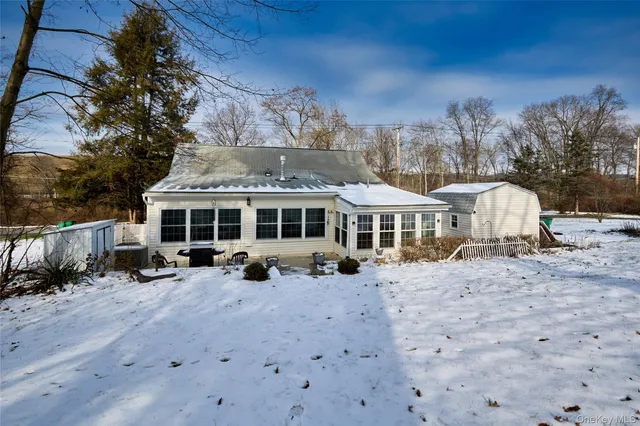 a view of a house with yard and sitting area