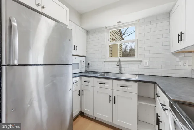 a sink with white cabinets