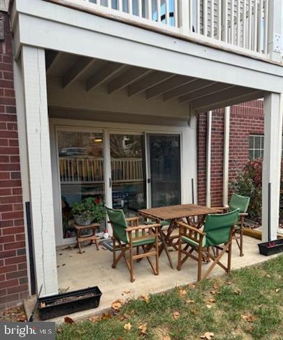 a view of a dinning table and chairs in patio of the house