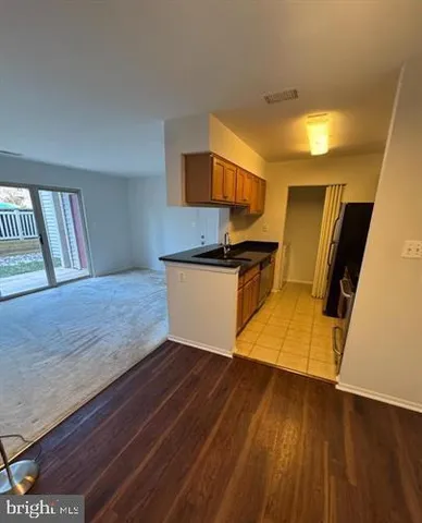 a view of kitchen with wooden floor and electronic appliances