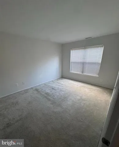 an empty room with a empty space and window