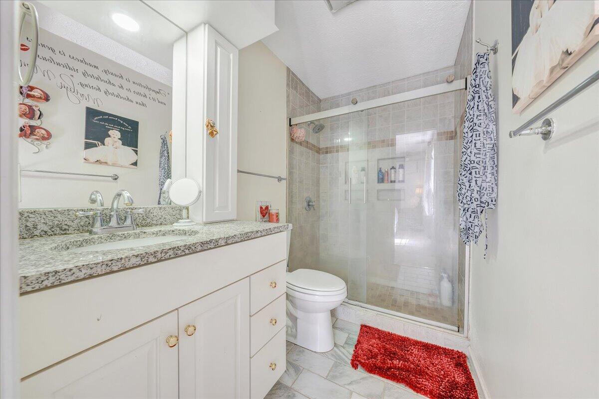 5497 Bethany Road Rustburg, VA 24588 - Photo 15 of 52 a bathroom with a granite countertop sink a toilet a shower and a mirror
