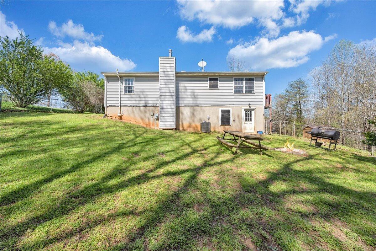 5497 Bethany Road Rustburg, VA 24588 - Photo 34 of 52 a view of a house with a big yard and large trees