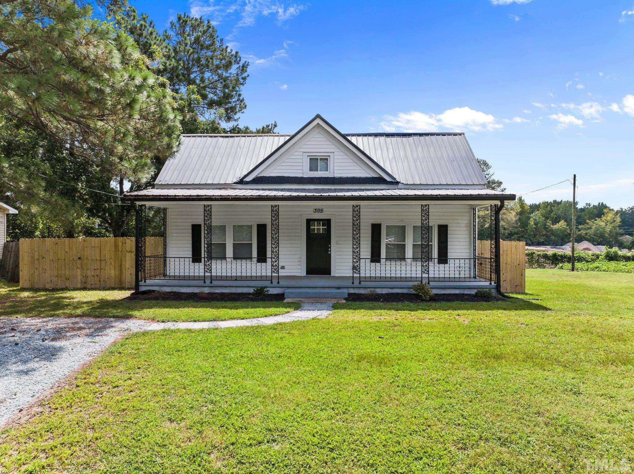 305 West Horton Street Zebulon, NC 27597 - Photo 1 of 29 a front view of a house with swimming pool having outdoor seating
