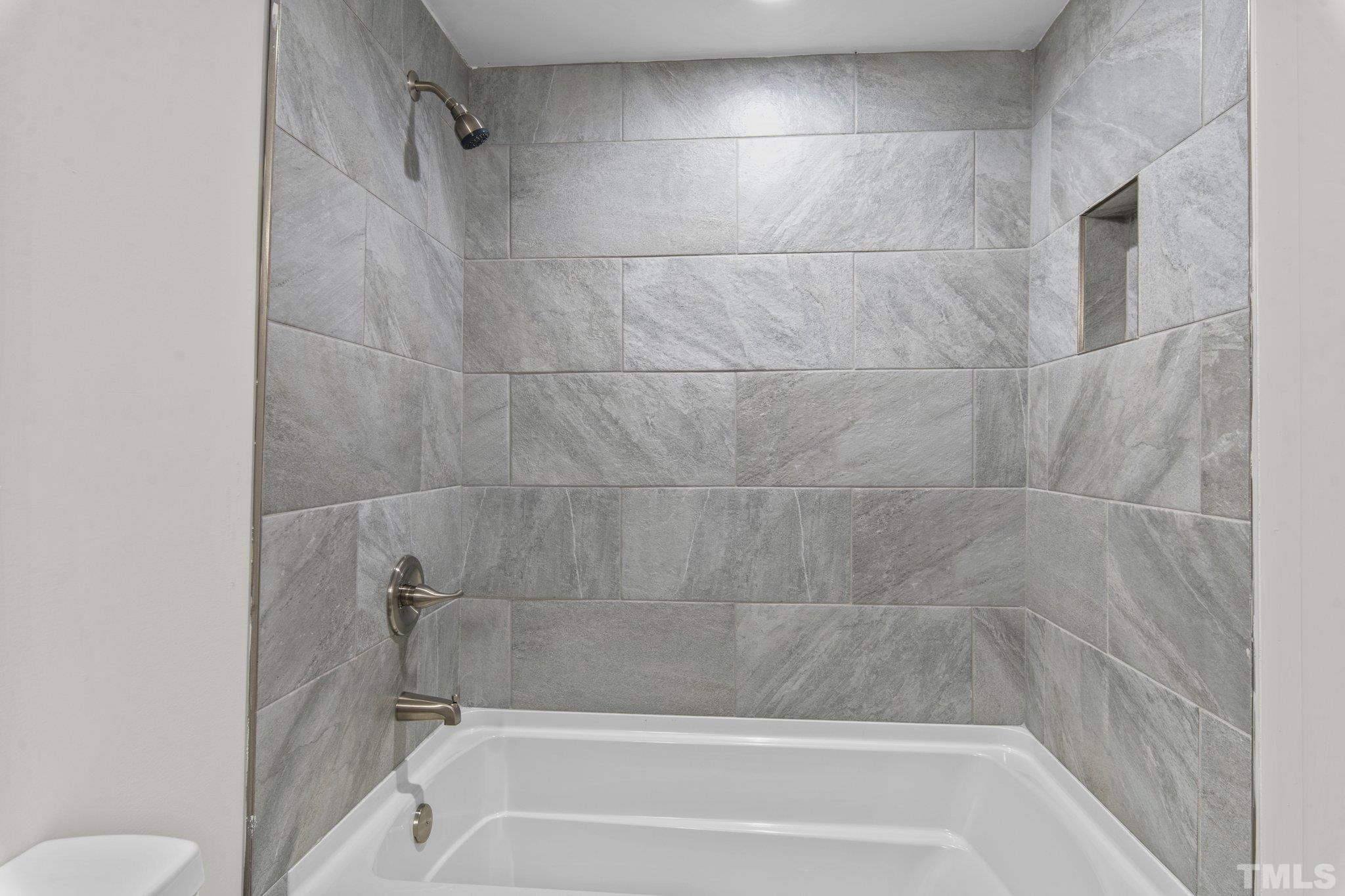 305 West Horton Street Zebulon, NC 27597 - Photo 17 of 29 a bathroom with a shower and toilet