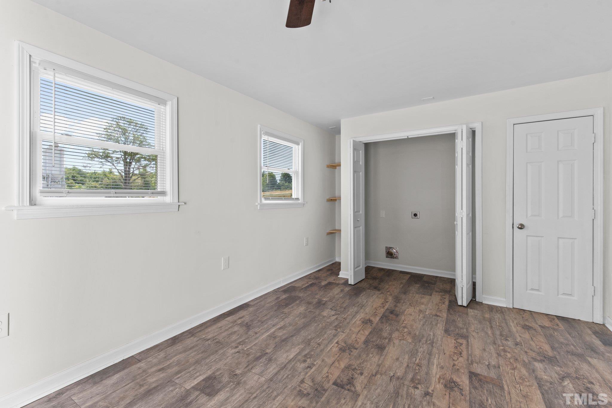 305 West Horton Street Zebulon, NC 27597 - Photo 18 of 29 a view of an empty room with wooden floor and closet