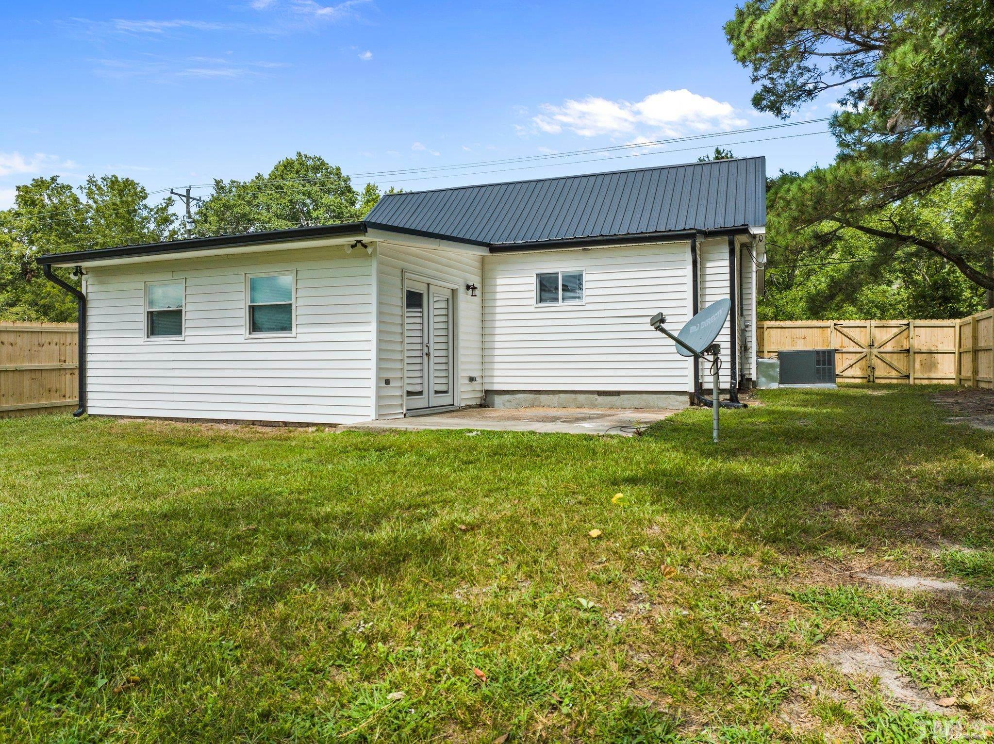 305 West Horton Street Zebulon, NC 27597 - Photo 24 of 29 a house view with a garden space