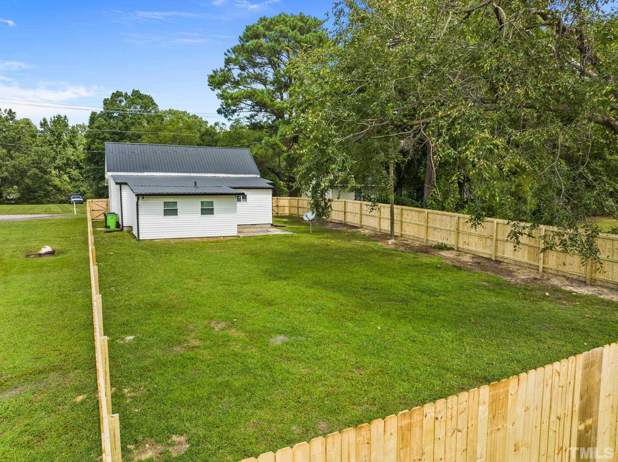 305 West Horton Street Zebulon, NC 27597 - Photo 26 of 29 a view of house with backyard