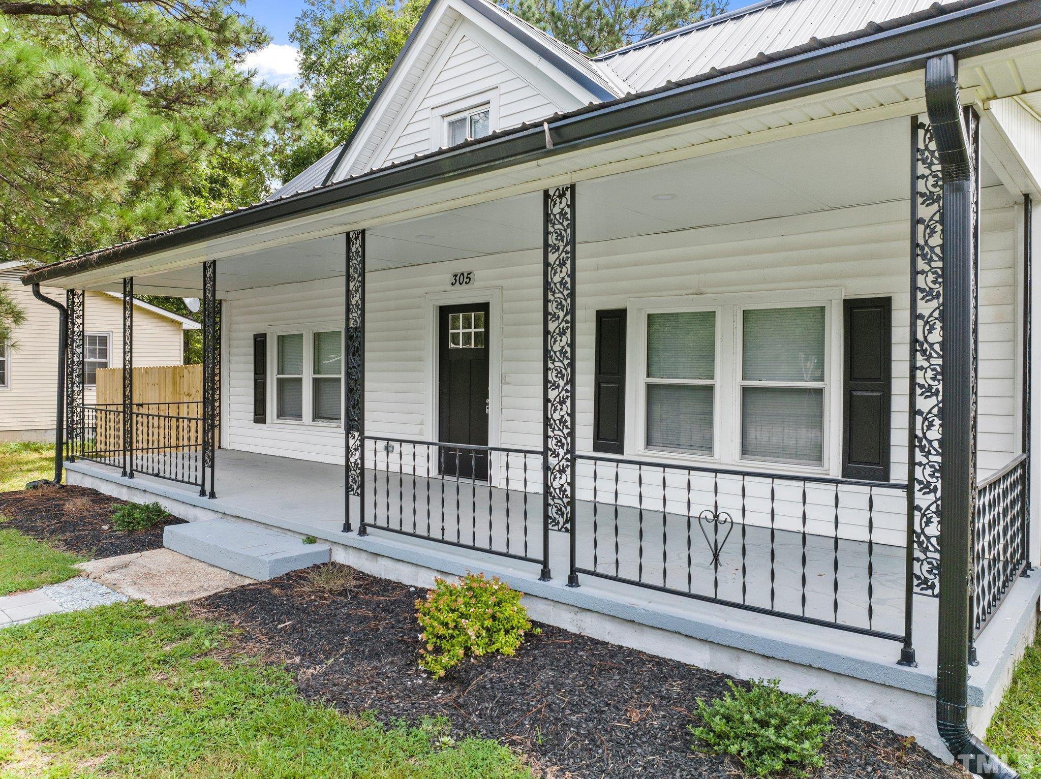 305 West Horton Street Zebulon, NC 27597 - Photo 3 of 29 a view of a house with a yard and sitting area