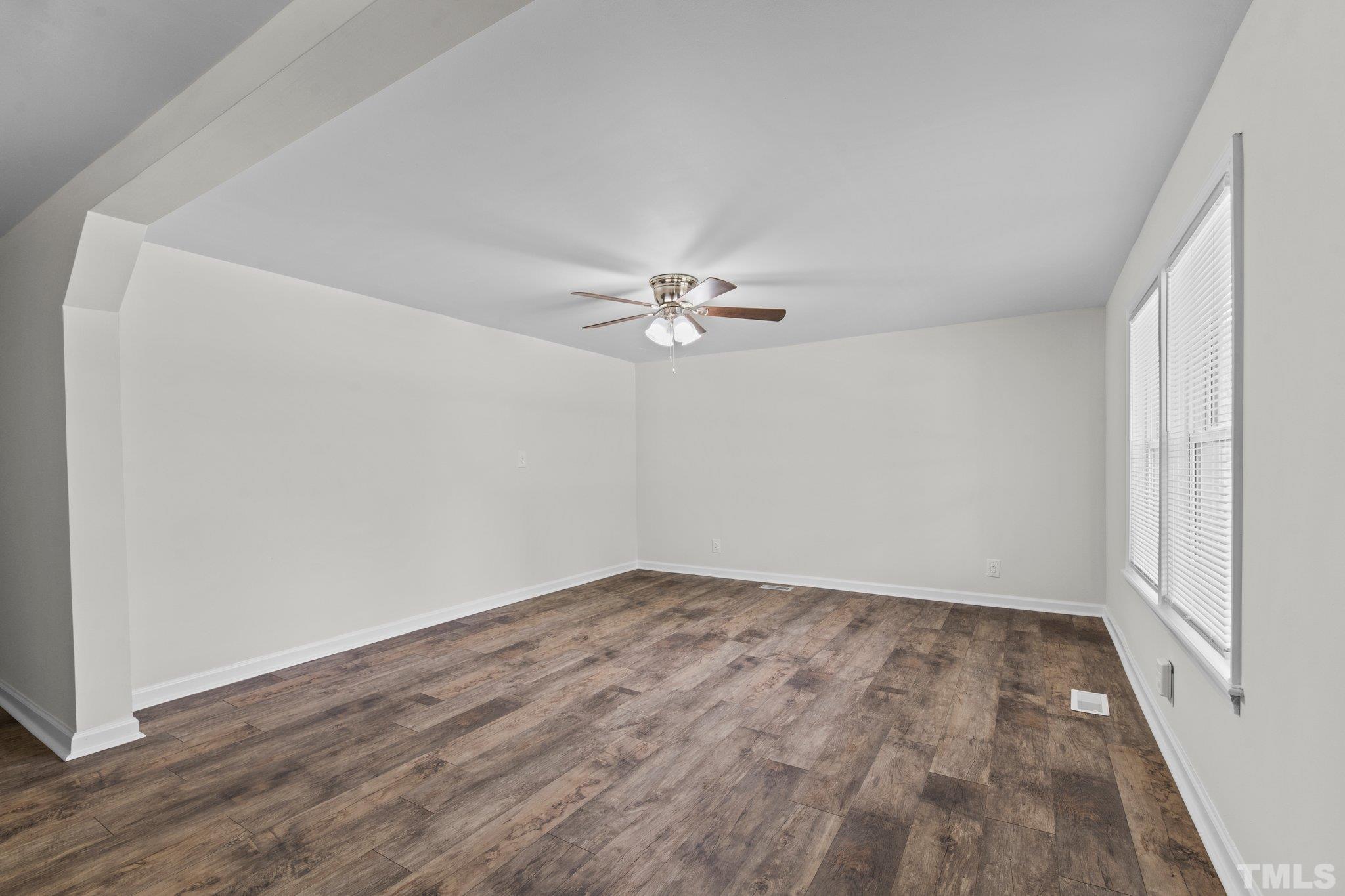 305 West Horton Street Zebulon, NC 27597 - Photo 6 of 29 a view of a room with wooden floor and a ceiling fan