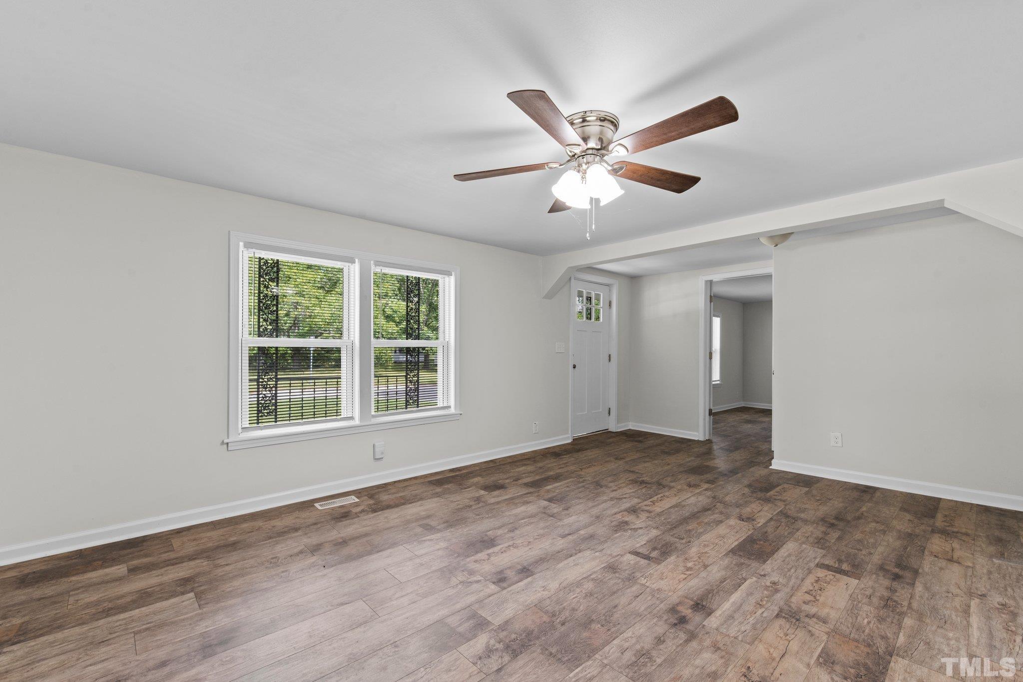 305 West Horton Street Zebulon, NC 27597 - Photo 10 of 29 a view of empty room with wooden floor and fan