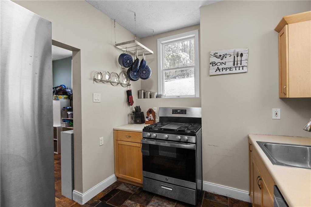 325 East Grant Street Houston, PA 15342 - Photo 15 of 33 a kitchen with a stove and a refrigerator