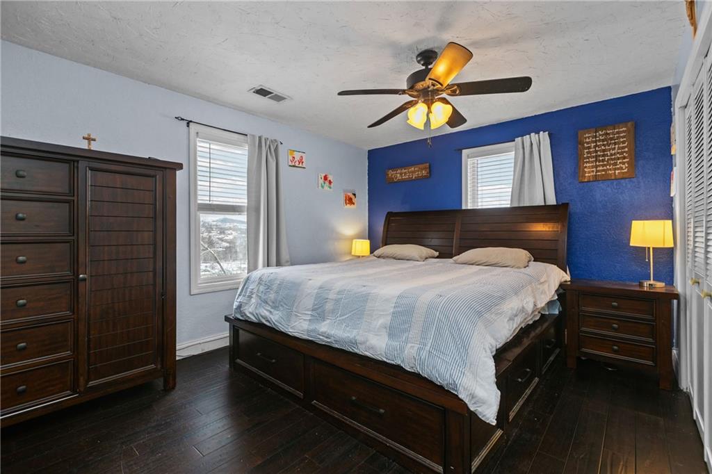 325 East Grant Street Houston, PA 15342 - Photo 22 of 33 a bedroom with a bed and wooden floor