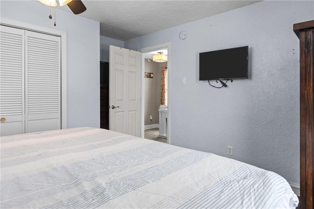 325 East Grant Street Houston, PA 15342 - Photo 23 of 33 a bedroom with a bed and a flat tv screen on wall