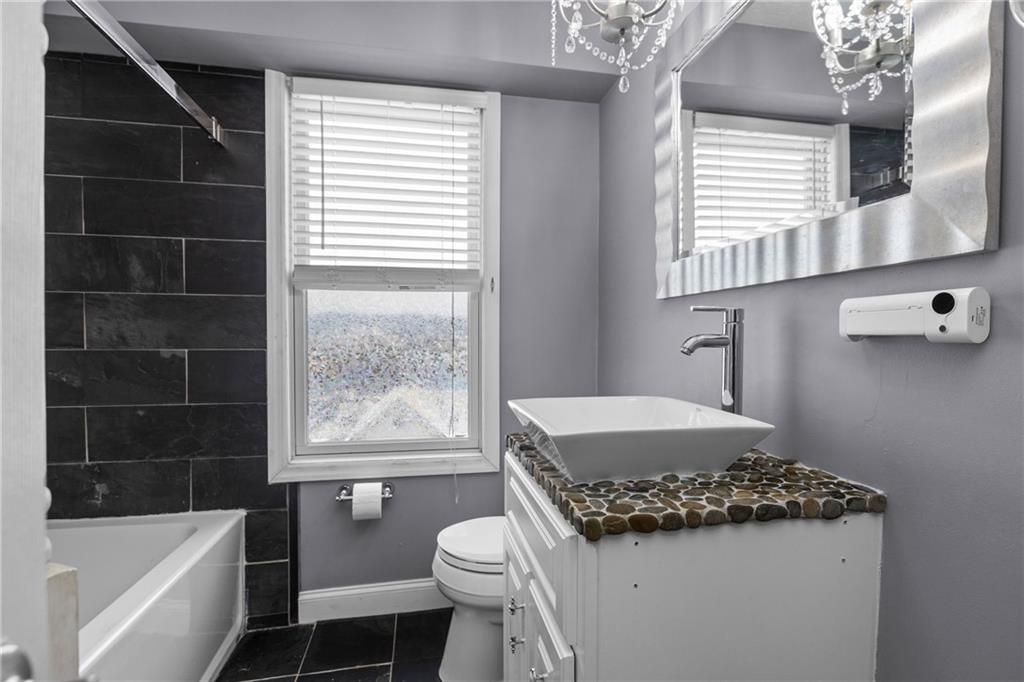 325 East Grant Street Houston, PA 15342 - Photo 26 of 33 a bathroom with a granite countertop sink toilet a mirror and bathtub