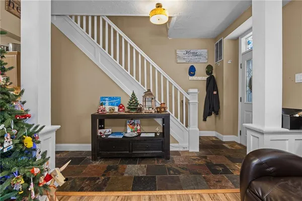 a living room with furniture and a chandelier