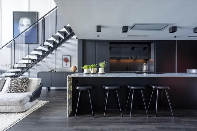 a kitchen with a table chairs and wooden floor