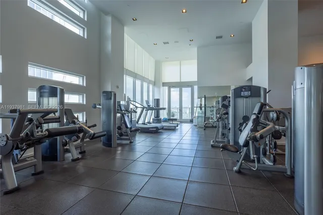 a bathroom with a sink a mirror and potted plant