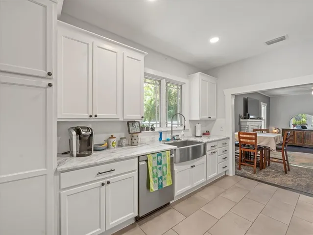 a kitchen with appliances a sink and cabinets