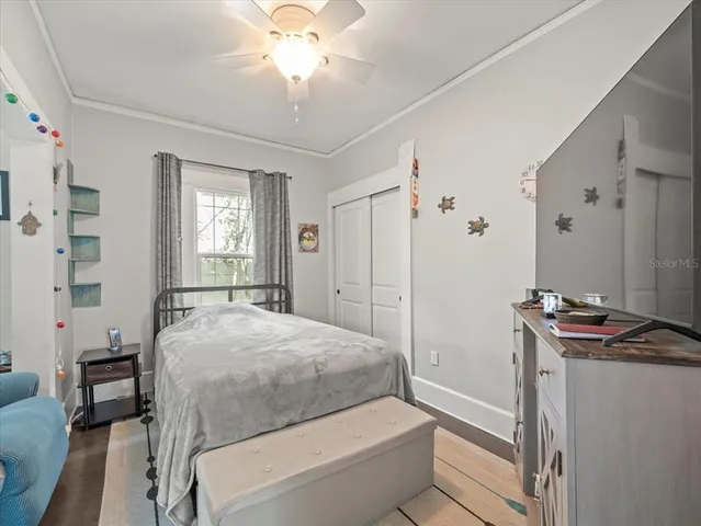 a bedroom with a bed and a chandelier