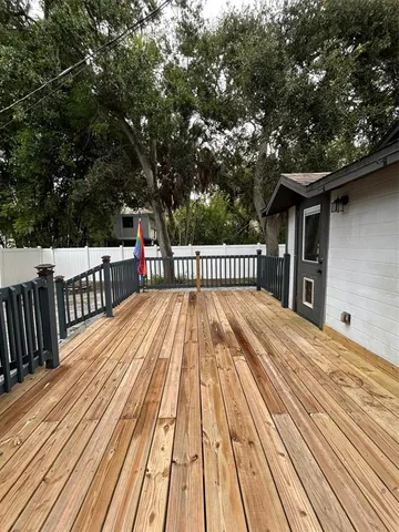 a view of backyard with deck and wooden floor