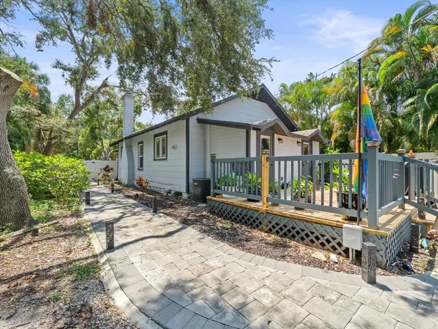 a wooden bench sitting in front of a house