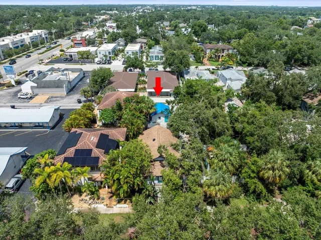 an aerial view of a house with a yard and lake view