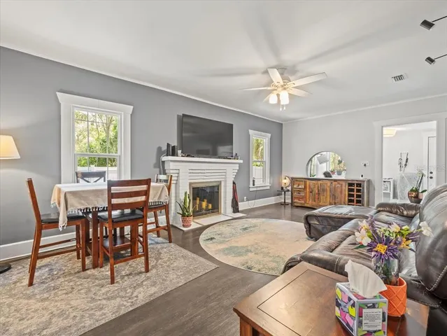 a living room with fireplace furniture and a flat screen tv