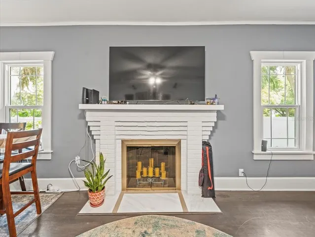 a living room with a fireplace and windows