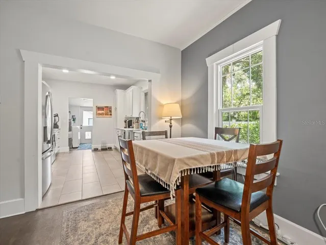 a dining room with furniture and window
