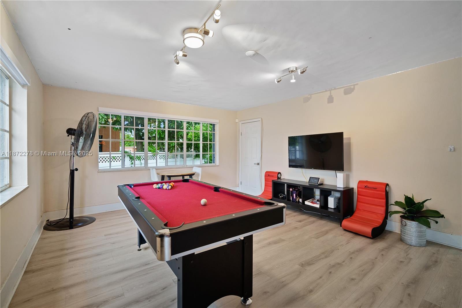 951 Northwest 148th Street Miami, FL 33168 - Photo 14 of 34 a living room with furniture pool table flat screen tv and windows
